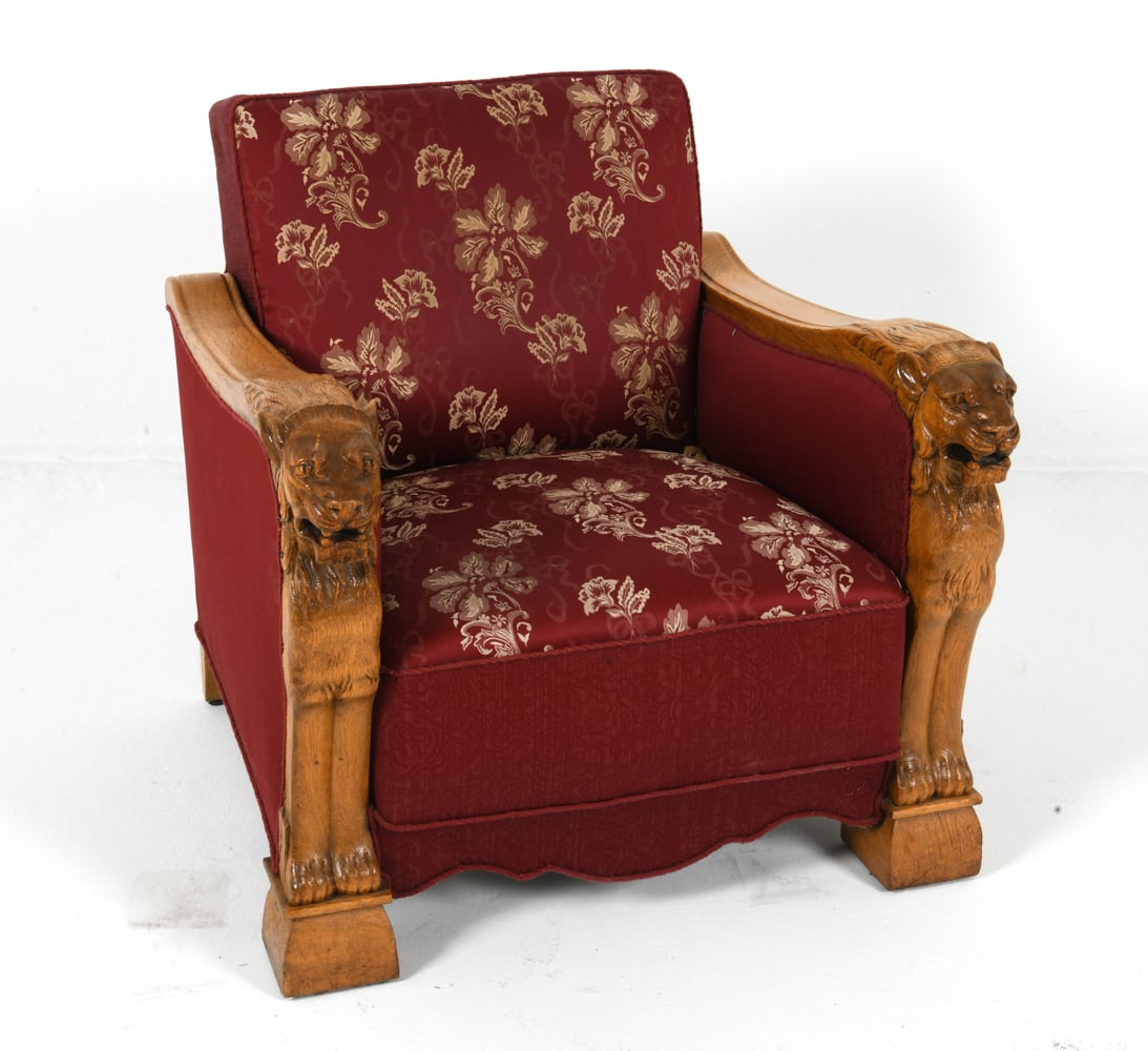 DANISH CARVED OAK LION LOUNGE CHAIR C. 1930S: Lounge chair with oak frame and carved lions to arms. Silk floral patterned upholstery. Denmark, circa 1930s. Dimensions: H 29" x W 31" x D 33" S.H. 17" Condition: Showing signs of wear including