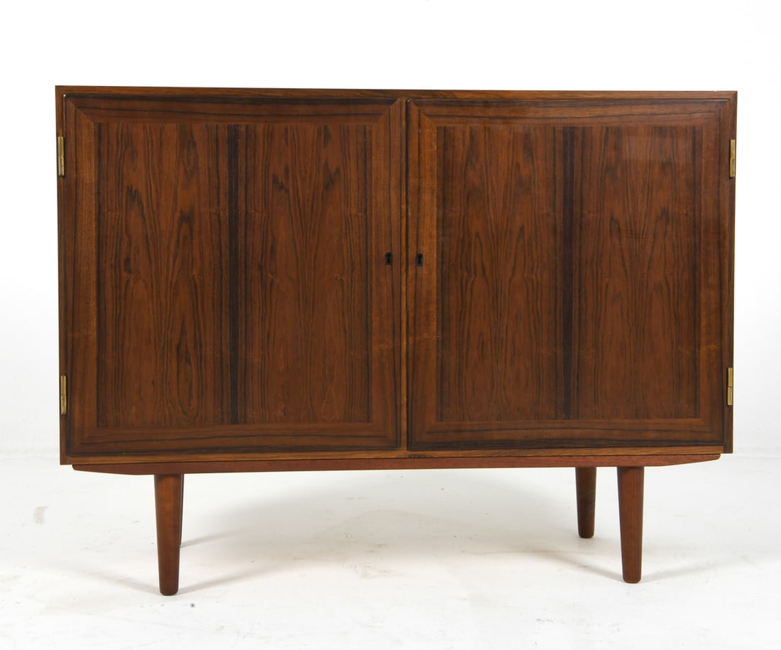 KAI WINDING DANISH ROSEWOOD CABINET C. 1960S: Key included. Adjustable shelves. Apparently untagged with Danish manufacturing mark. Denmark, circa 1960s. Dimensions: H 32.5" x W 43.5" x D 16" Condition: Showing signs of wear including repair to i