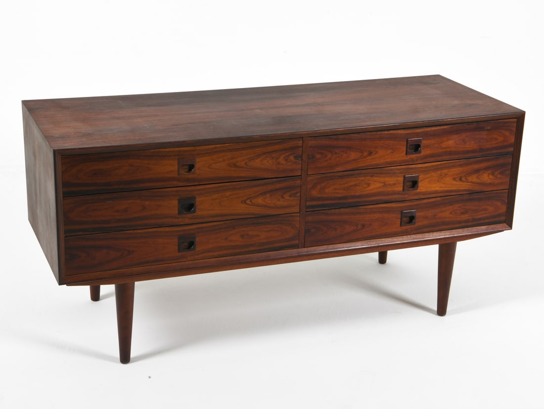 ERIK BROUER DANISH ROSEWOOD CHEST C. 1960S: Molded inset drawer pulls. Apparently untagged. Denmark, circa 1960s. Dimensions: H 25.5" x W 53" x D 19.5" Condition: Showing signs of wear including mild sun fading to top. Wear consistent with age