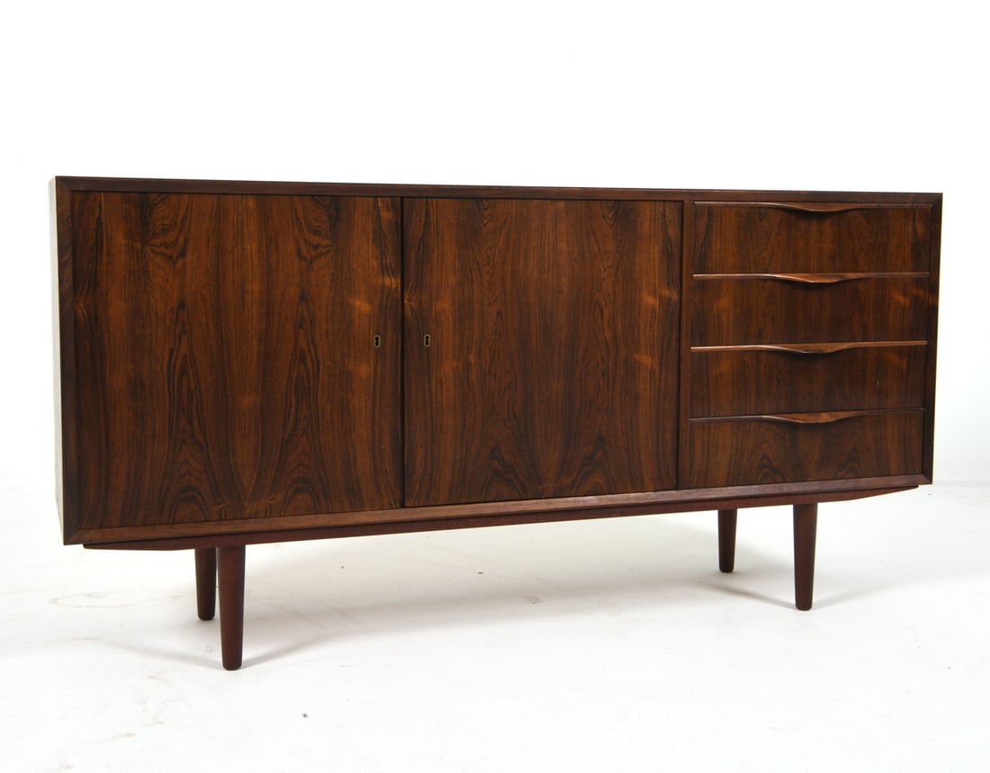 ERVING TORVITS DANISH ROSEWOOD SIDEBOARD: C. 1960s Dimensions: H 29.5" x W 59" x D 14.5" Condition: With light sun fading to top. Wear consistent with age and gentle use. J056