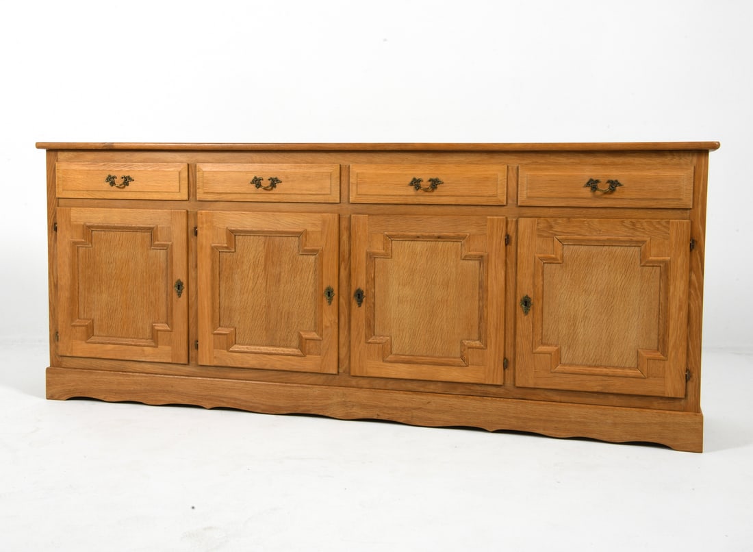 HENNING KJAERNULF STYLE DANISH OAK SIDEBOARD 1970S: Key included. Adjustable shelves. Brass pulls. Felt lined drawers. Denmark, circa 1970s. Dimensions: H 31" x W 78" x D 17". Condition: Presents well overall. J085