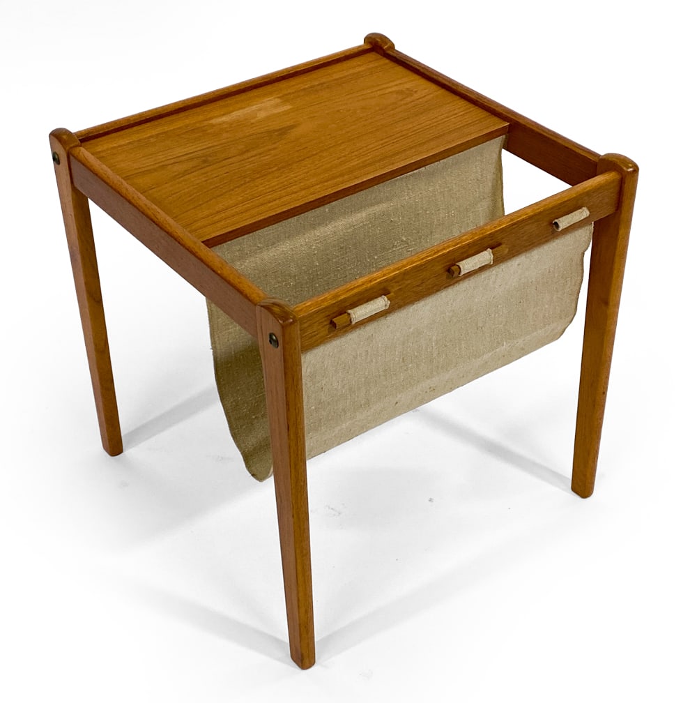 BRDR FURBO DANISH TEAK MAGAZINE RACK C. 1960S: Teak frame with linen fabric sling to hold magazines or newspapers. Tagged to the underside. Denmark, circa 1960s. Dimensions: H 18.25" x W 17.75" x D 18". Condition: Few faded spots to top. Wear cons