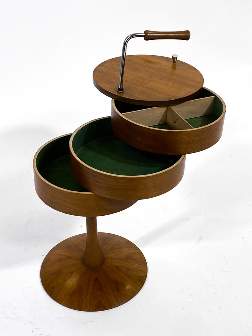 DANISH TEAK SEWING COMPARTMENT SIDE TABLE C. 1960S: Teak sewing table with drum-shaped body. Top compartments slide out from one-another. Felt lined compartment. Denmark, circa 1960s. Dimensions: H 26.5" x W 16.5" x D 11.5". Condition: Few nicks and sc
