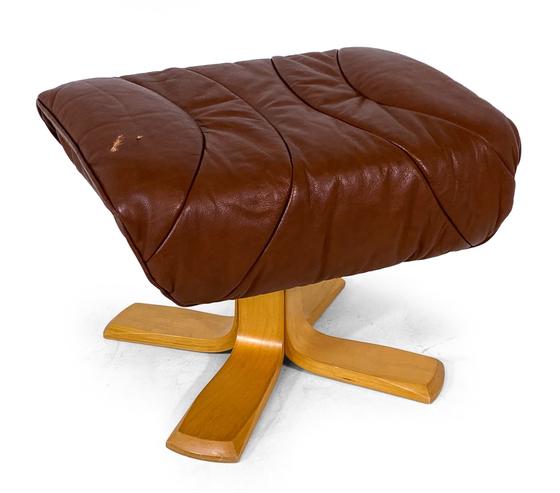 SCANDINAVIAN LEATHER AND BEECH FOOTSTOOL OTTOMAN: C. 1970s Dimensions: H 16" x W 22" x D 17" Condition: Showing signs of wear including scuff, loss to leather as shown. J155
