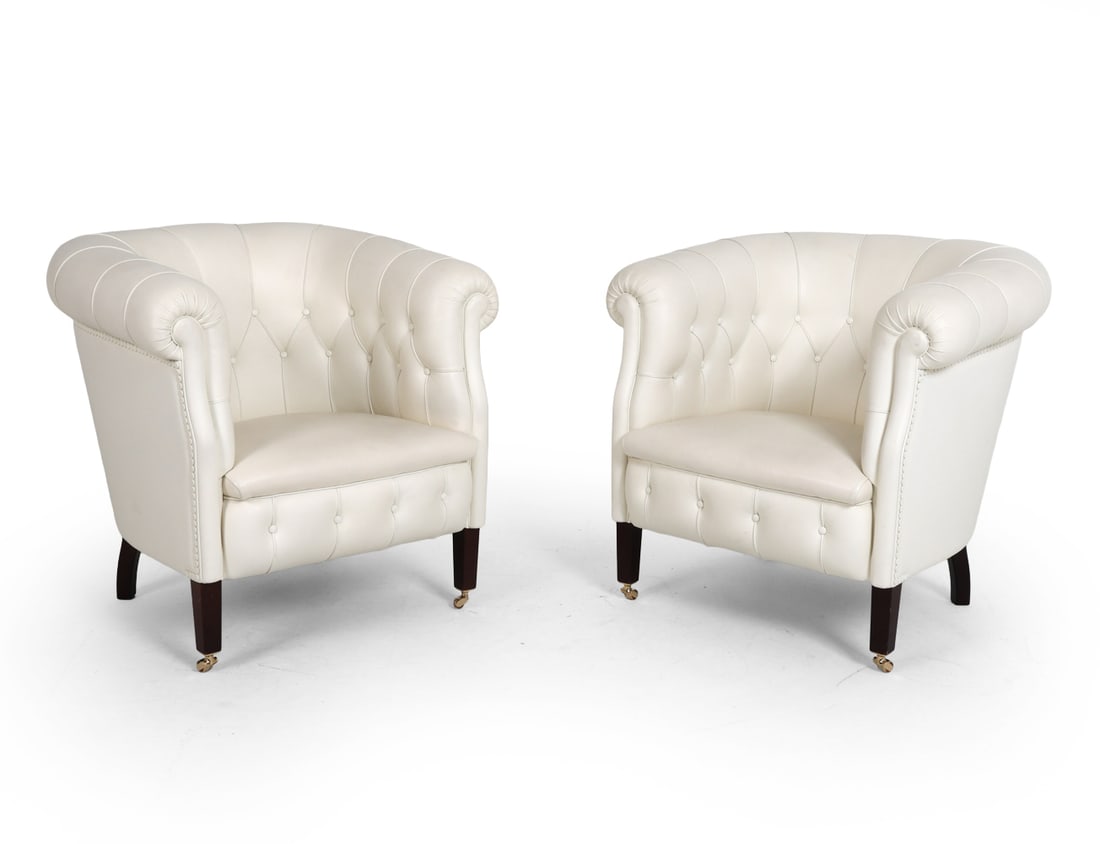 PAIR POLTRONA FRAU ITALIAN TUFTED LEATHER CHAIRS: Limited edition. Official reissue of the Fumoir model originally designed in 1929 by Poltrona Frau in Italy. White tufted leather upholstery with beech feet and casters to front. Labeled and dated 201