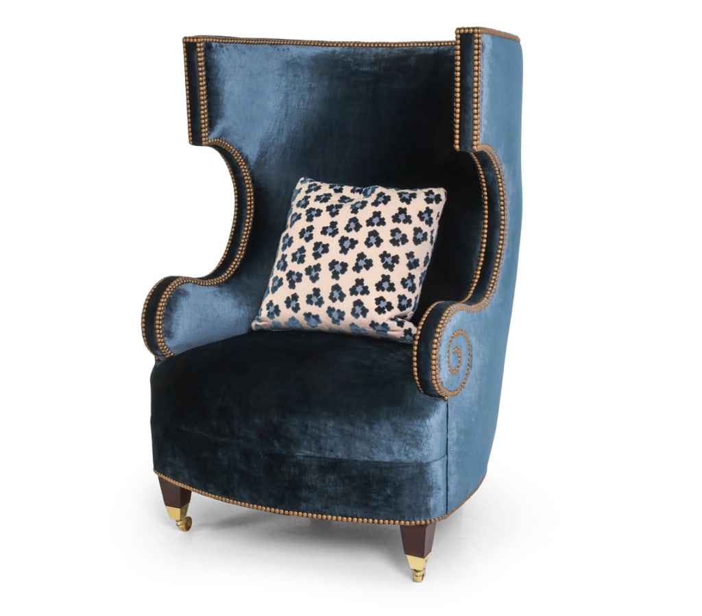 CUSTOM 'WELLINGTON' VELVET WINGBACK CHAIR: Custom Wellington wingback lounge chair designed by Eric Lysdahl. Chair features hand-applied brass nail trim and tapered wooden legs on brass casters. Reupholstered to steel blue-colored silk velvet