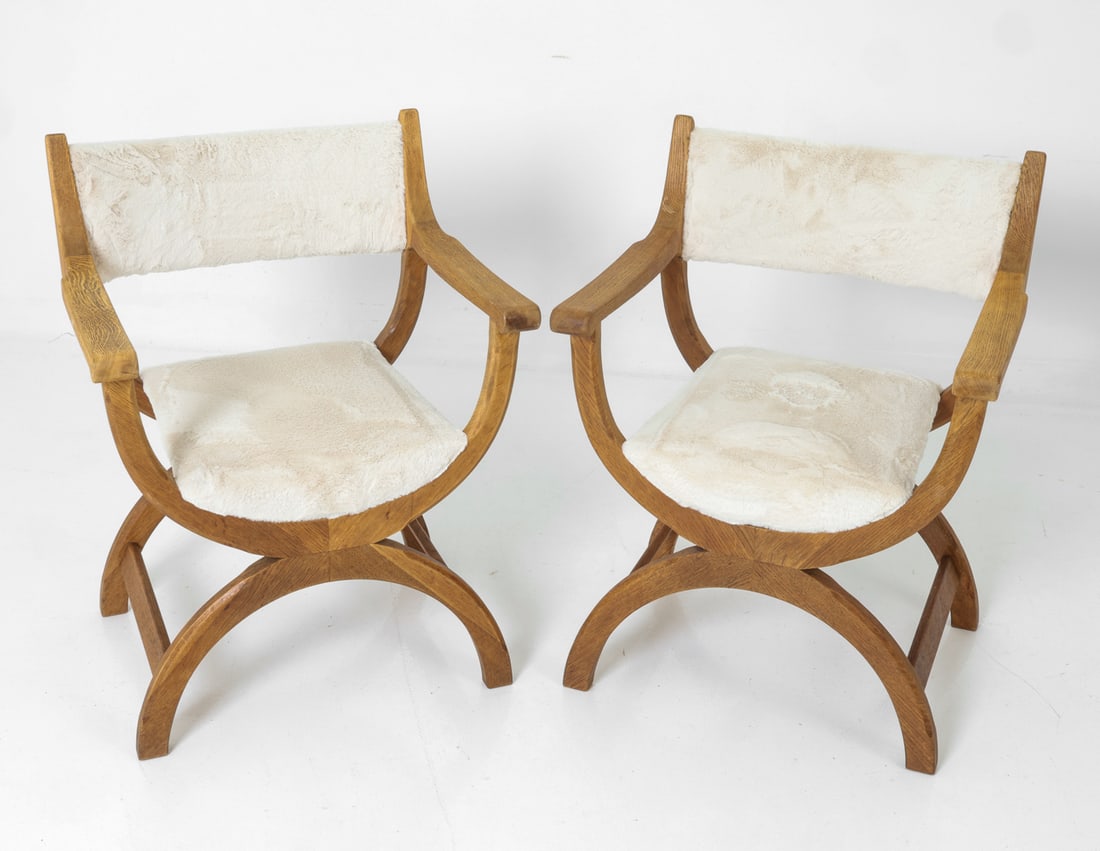 PAIR OF HENNING KJAERNULF "KURUL" ARMCHAIRS 1960S: For EG Kvalitetsmobel. Danish oak chair in curved contours and beige faux shearling upholstery. Tagged to frame. Denmark, circa 1960s. Dimensions: H 33" x W 24.5" x D 21" x Sh 17.5" Condition: Wear co