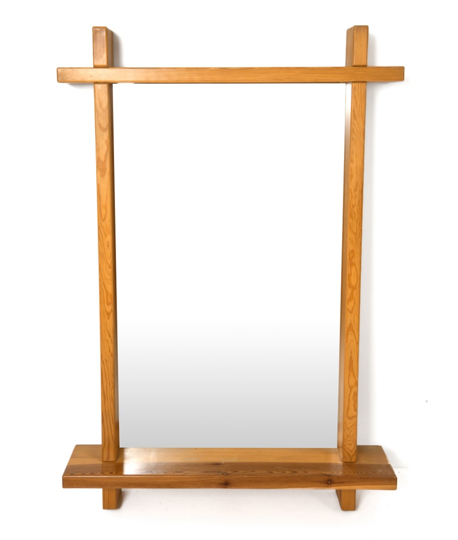SWEDISH PINE WALL MIRROR CIRCA 1970S: With a bottom shelf. Dimensions: (Frame) H 51.5" x W 34.5" (Mirror) H 40" x W 24.25" Condition: Wear consistent with age and use. Scuffs, rubs to frame.