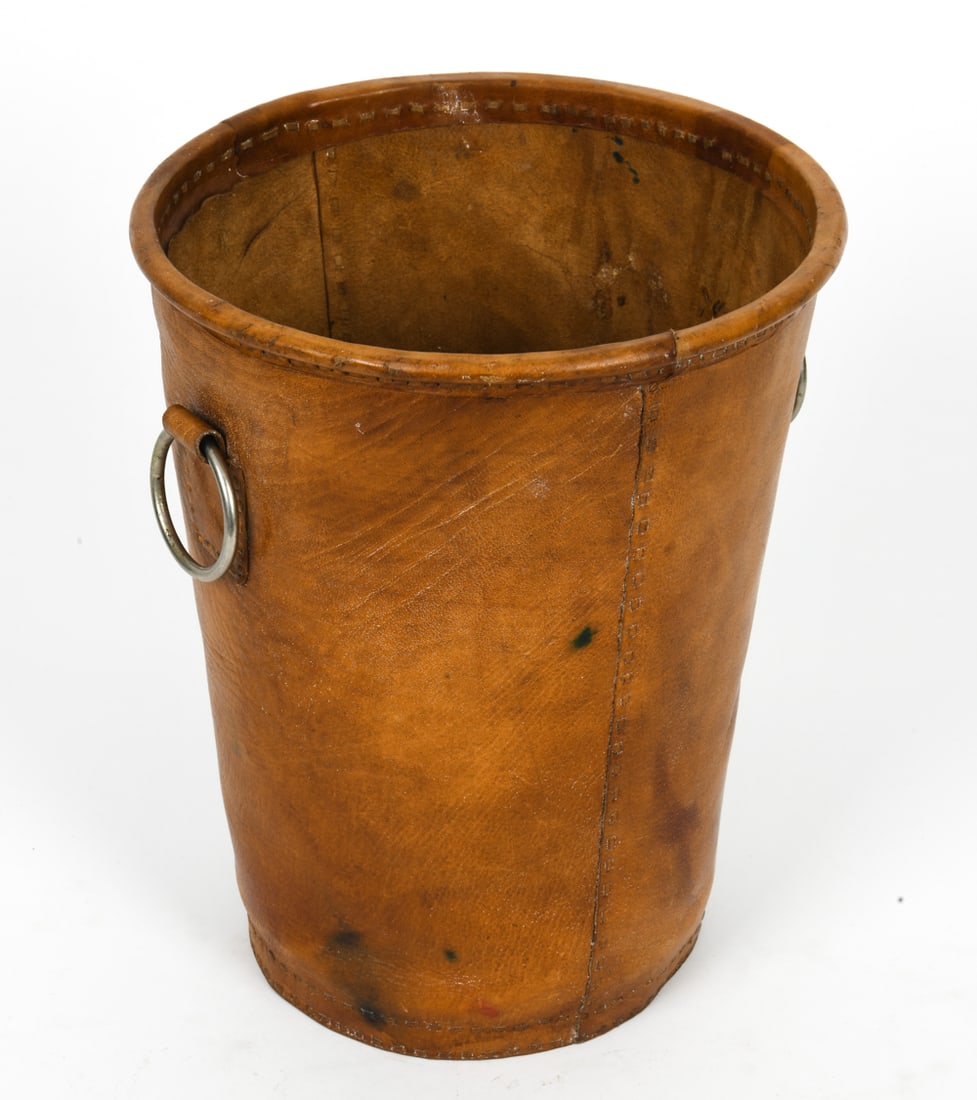 DANISH SADDLE LEATHER WASTE BASKET: Utility bucket or wastepaper basket with stitched seams and metal ring handles. Marked "HOME DAY Birger Et Mikkelsen" on side. Denmark. Dimension: H 13" x Dia.10.5" Condition: Marks of discoloration,