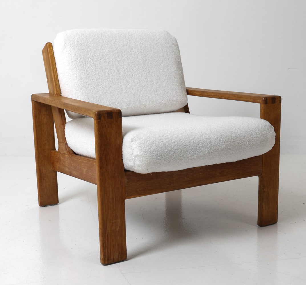 ASKO STYLE DANISH OAK LOUNGE CHAIR C. 1960S: Brutalist armchair in boucle upholstery with oak frame. Denmark, circa 1960's Dimensions: H 29" x W 30" x D 34" x SH 17" Condition: Wear consistent with age and use. Scuffs and fading to wood.