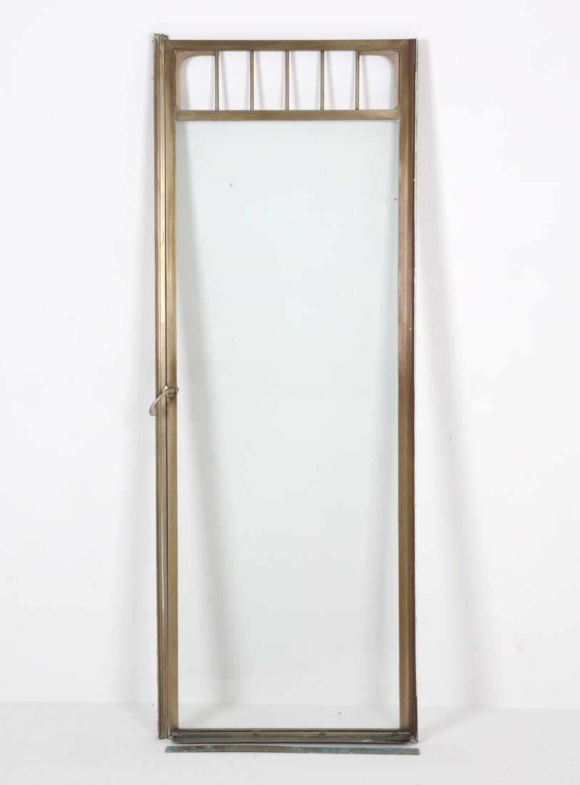 G. M. KETCHAM NICKEL FRAME GLASS DOOR: Includes wall and floor trim. Labeled upper front. . Dimensions: H 72" x W 26" x D 5.5". Condition: With light patina to nickel consistent with age and use.