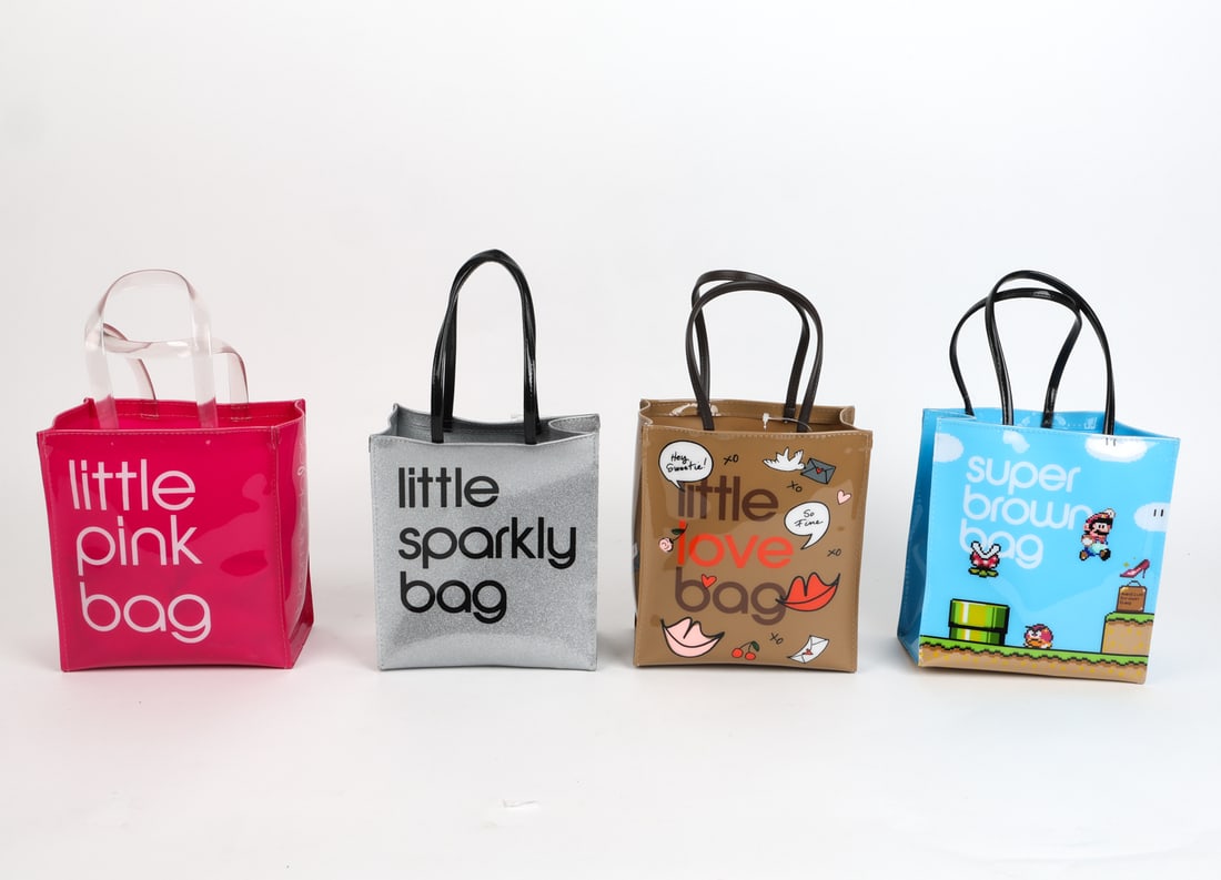 BLOOMINGDALE SMALL TOTE COLLECTION GROUPING: Includes (4) bags total, each with different design. Each tagged. Contemporary. Dimensions: H 14.5" x W 7.75" x D 4.75". Condition: In like new condition.