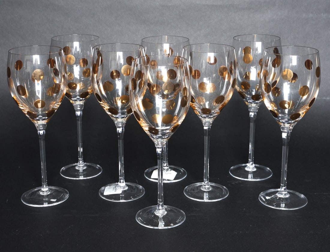 KATE SPADE PEARL PLACE GLASS GOBLETS: (8) Glass goblets featuring gold polka dot pattern. Labeled underneath. Dimensions: H 9.5" x Dia. 3". Condition: Minor scuffs to bases.
