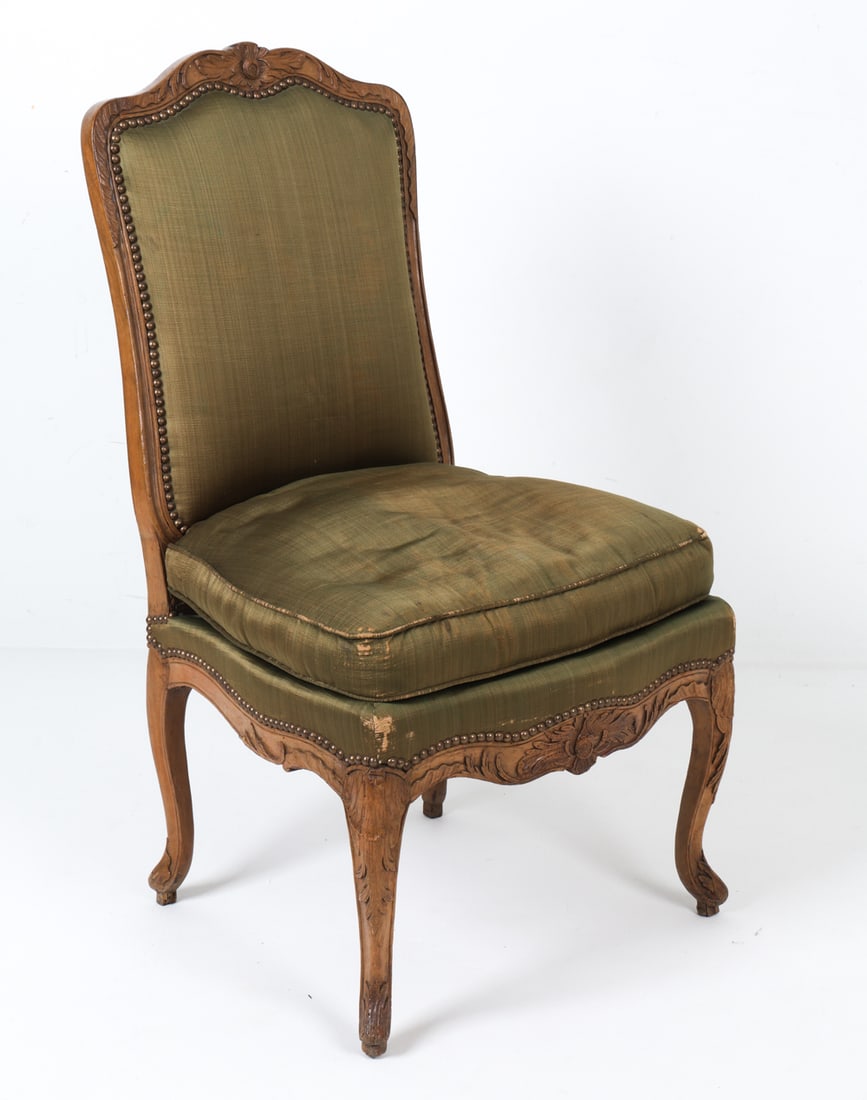 ANTIQUE LOUIS XV STYLE WALNUT & SILK DINING CHAIR: Carved walnut frame with green silk upholstery. Carved decoration to frame. Dimensions: H 40" x W 21" x D 21" x SH 19". Condition: Fading, rubs, and thinning to silk upholstery. Scuffs, scratches, and