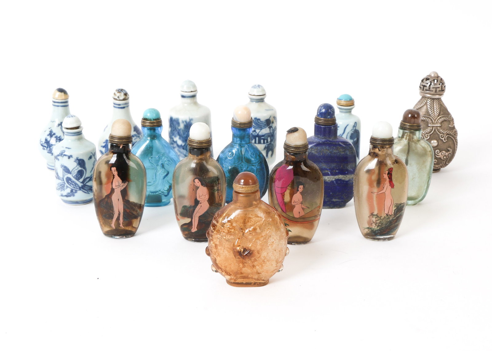 GROUPING OF CHINESE SNUFF BOTTLES: Grouping of snuff bottles including porcelain, carved stone and others. Features a set of four bottle with painted nude women. Some with Chinese character marks on undersides. Dimensions:(Largest) H 3