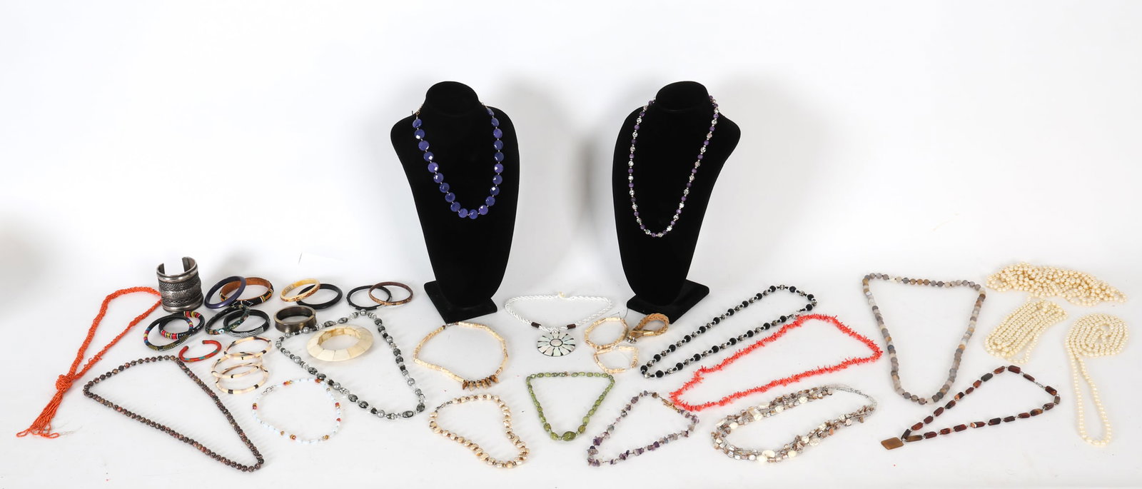 GROUPING OF COSTUME JEWELRY: Large grouping of beaded necklaces and bracelets. Materials include pearls, coral, metals, shells, plastic beads, etc. Contemporary. Dimensions: (Pearl necklace) L 35". Conditions: Wear consistent wit