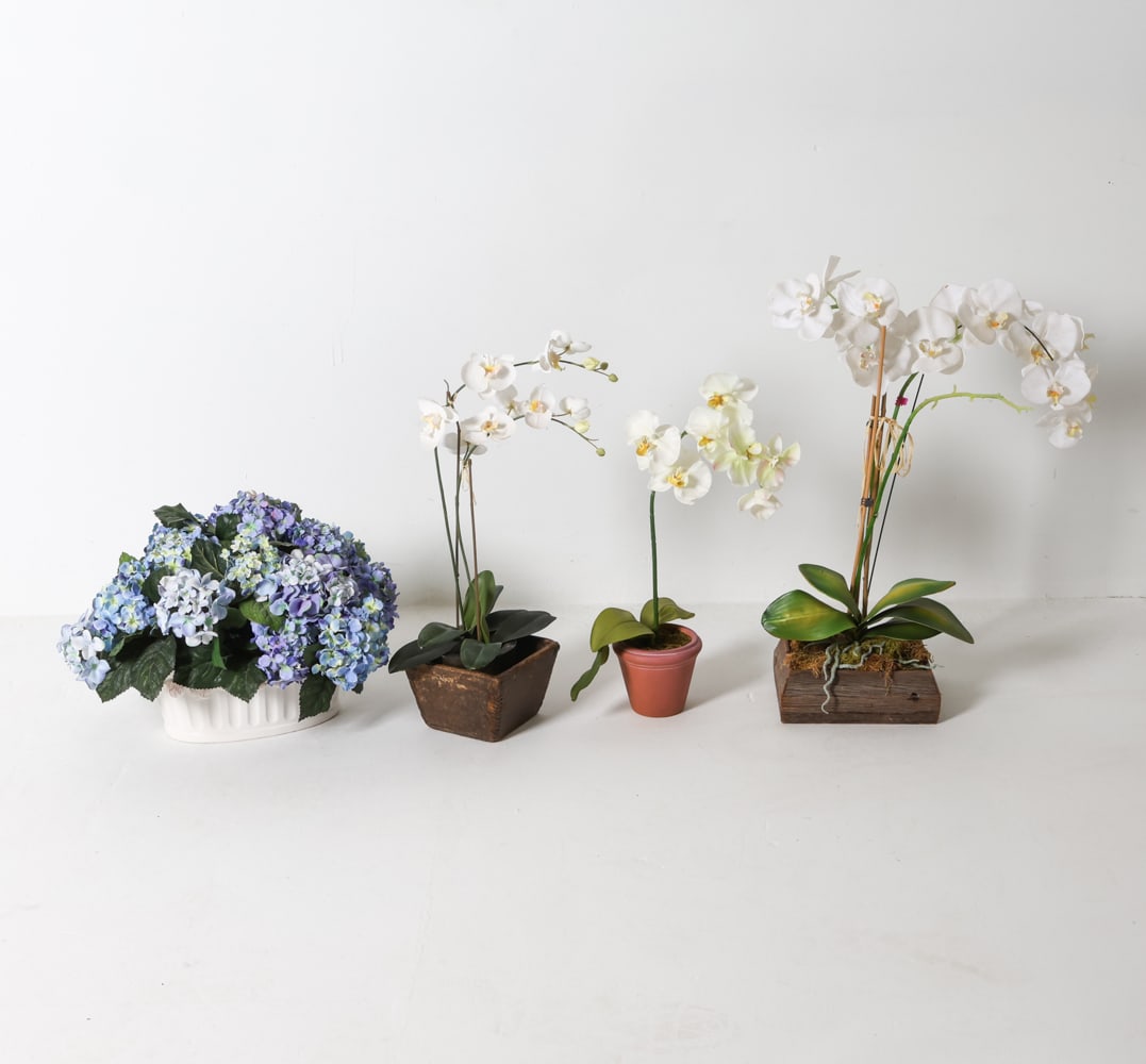 FAUX PLANTS GROUPING: Includes (4) pieces. Wooden and ceramic containers. Contemporary. Dimensions: (largest) H 17" x W 19" x D 16". Condition: Wear consistent with age and display.