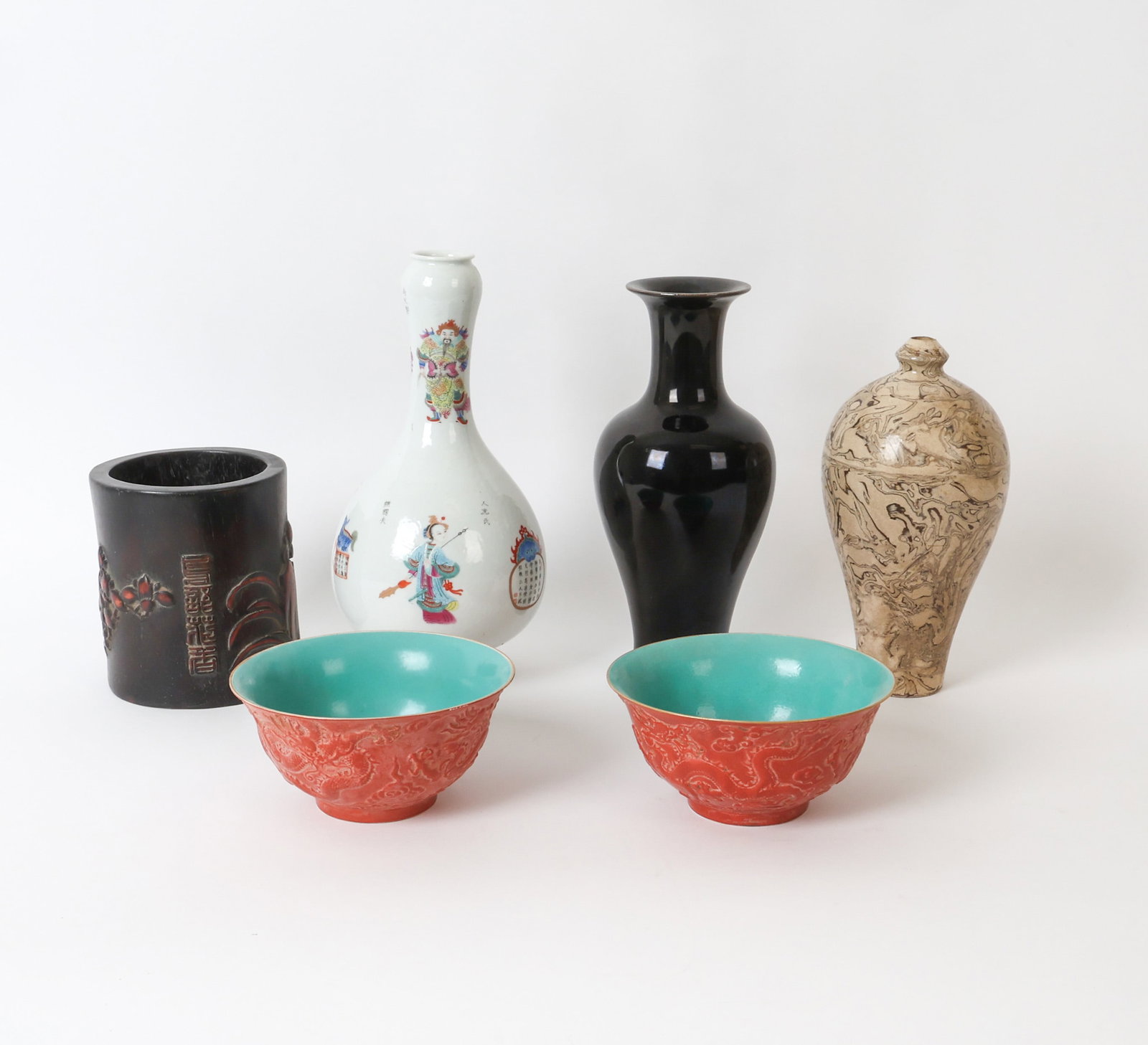 GROUPING OF CHINESE DECORATIVE PORCELAIN: Grouping includes various vases and a pair of bowls and a carved bamboo or wood brush pot, most with Chinese seals or characters on undersides. Dimensions: (Tallest) H 11.25" x Dia. 5.5" Condition: Li