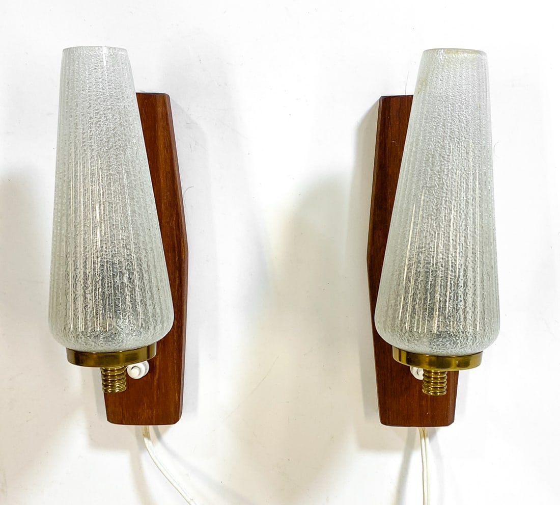 PAIR OF DANISH TEAK & GLASS WALL SCONCES C. 1960S: (2) Wall sconces with teak backings and conical glass shades. Denmark, circa 1960s. Dimensions: H 10" x W 2.5" x D 5.25". Condition: Wiring untested. Few minor scuffs. Wear consistent with age and use