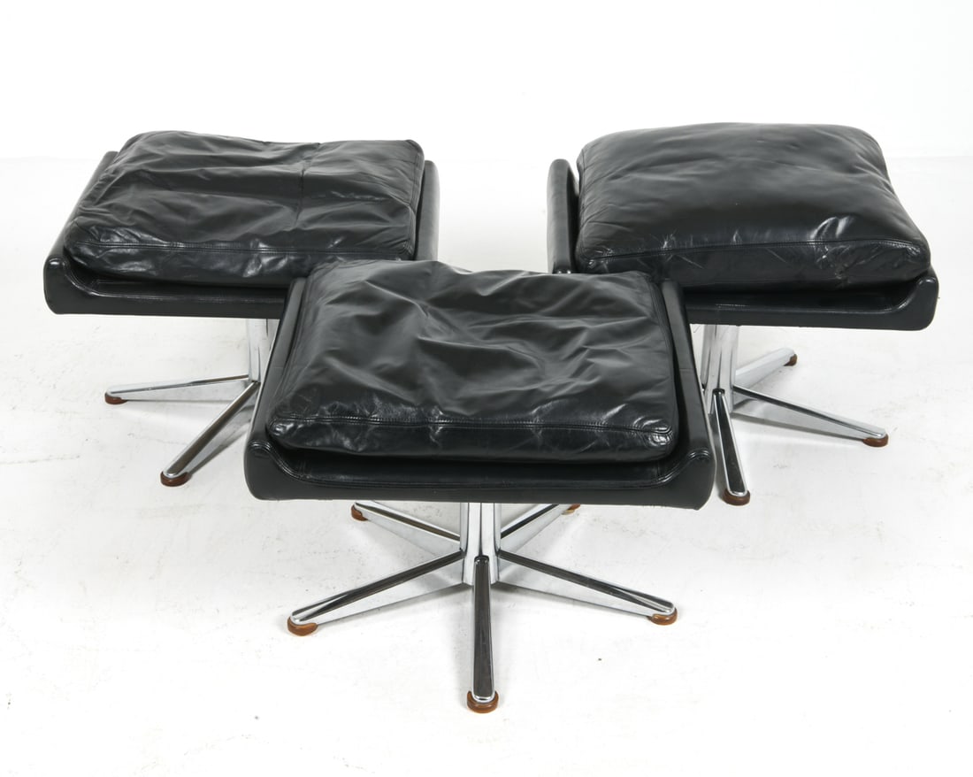 WERNER LANGENFELD LEATHER OTTOMANS GROUPING: For ESA Mobelvaerk. Upholstered with black leather. Apparently unmarked. Denmark, circa 1960s. Dimensions: H 17" x W 23" x D 19". Condition: Minor scuffs and rubs to leather and frame, wear consistent