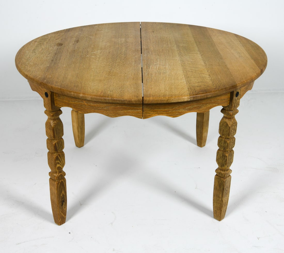 HENNING KJAERNULF STYLE OAK DINING TABLE: (2) Leaves included. Denmark, circa 1970s. Dimensions: H 29" x Dia. 45". Leaves 25.5". Condition: Minor scuffs and dings, wear consistent with age and use.