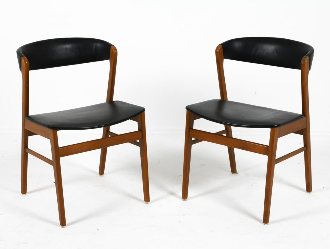 PAIR KAI KRISTIANSEN TEAK DINING CHAIRS 1970S: Teak frames with black vinyl upholstery. Apparently unmarked. Denmark, circa 1970s. Dimensions: H 29.5" x W 19.25" x D 19.5" x Sh 18.25". Condition: Rubs and scuffs to to armrest and legs, punctures t