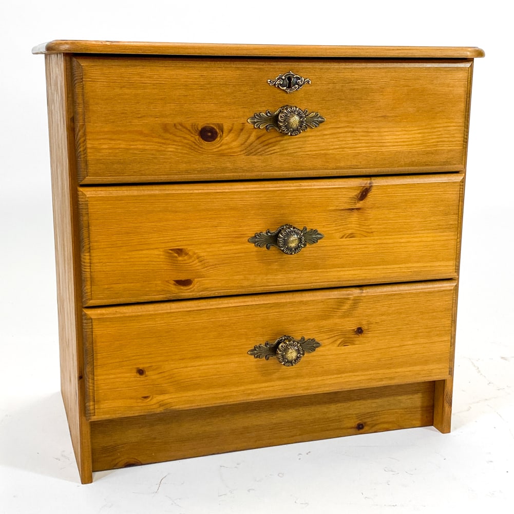 SWEDISH PINE NIGHT STAND SIDE CHEST C. 1960S: Small pine chest of drawers with brass drawer pulls. Sweden, circa 1960s. Dimensions: H 23.5" x W 22.5" x D 14.5". Condition: Minor scuffs and dings, wear consistent with age and use.