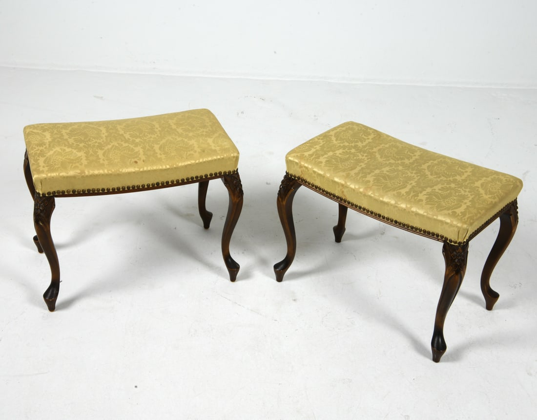 PAIR OF QUEEN ANNE STYLE WALNUT OTTOMAN STOOLS: (2) Ottoman stools with walnut frames and white silk upholstery. Brass tacks accent. Scandinavian, mid 20th century. Dimensions: H 17" x W 21.5" x D 13.5". Condition: Showing signs of wear including l