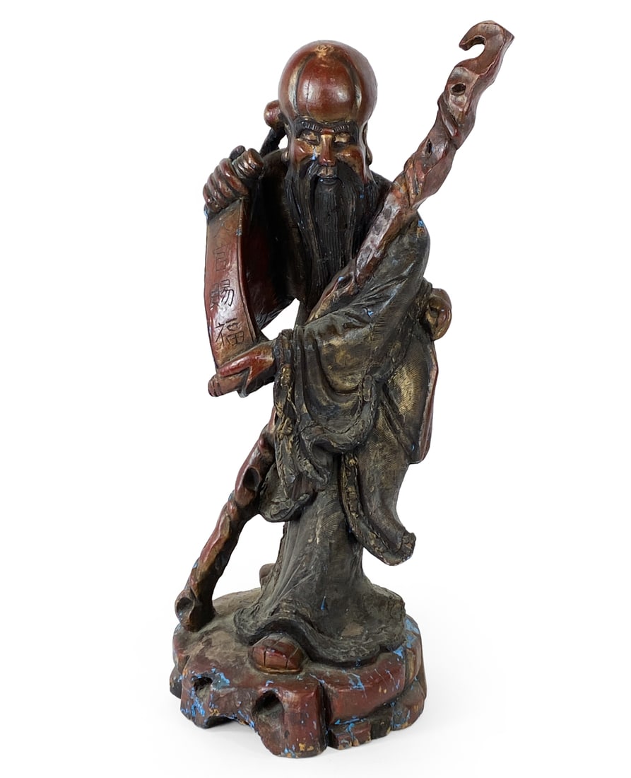 CHINESE CARVED WOOD IMMORTAL FIGURE STATUE: Carved and painted figure of an immortal man. Symbolizes longevity and health. Chinese, early 20th century. Dimensions: H 33.5" x Dia. 13". Condition: Scratches, dings, and few stress cracks. Wear con