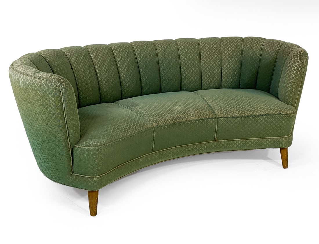 DANISH GREEN BANANA SOFA C. 1960S: Green boucle fabric upholstery with channel back design. Beech feet. Denmark, circa 1960s. Dimensions: H 31" x W 70" x D 37" x SH 17". Condition: Fading and wear to fabric on seat and top edges. Wear