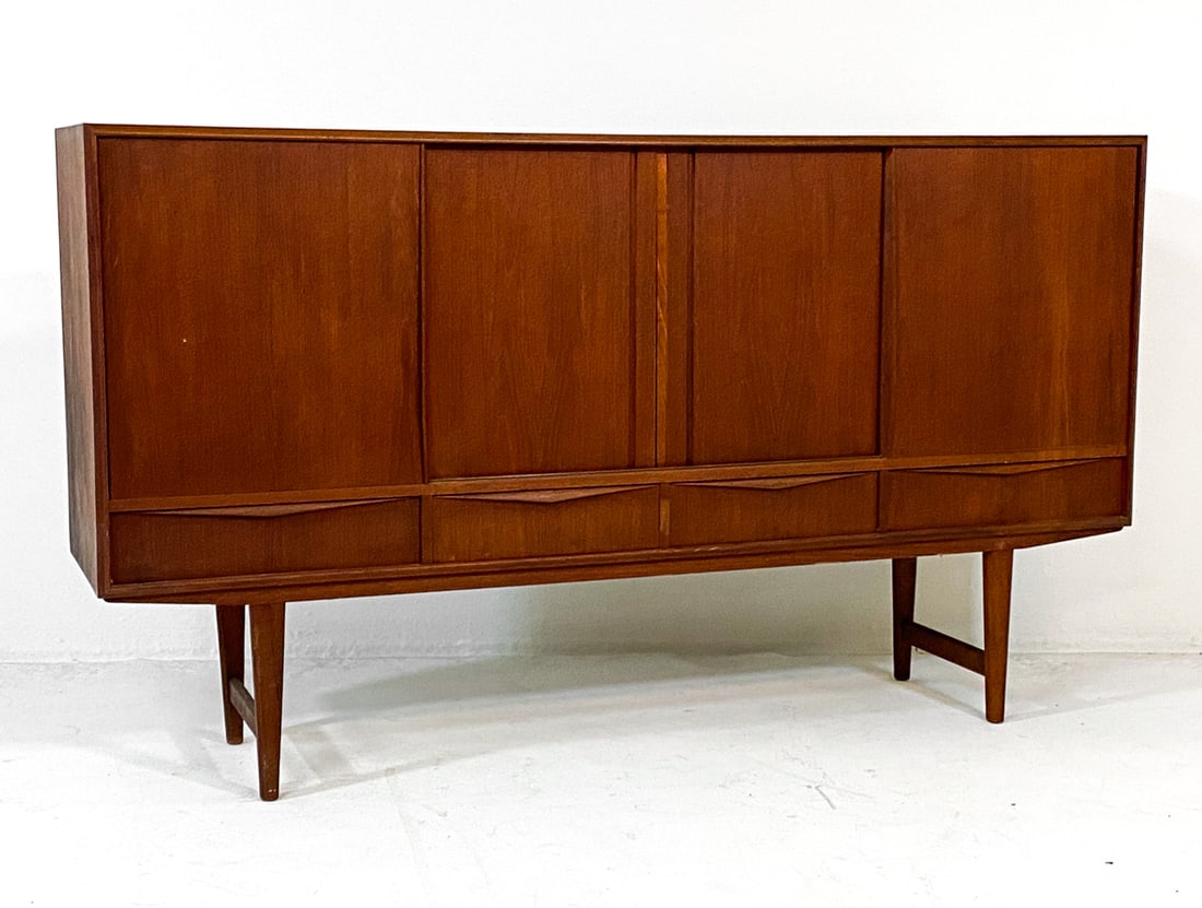 E. W. BACH DANISH TEAK SIDEBOARD C. 1960S: For Sejling Skabe. Teak sideboard with sliding cabinet doors. Mirror backing to cabinet in center. Adjustable shelves. Apparently untagged. Denmark, circa 1960s. Dimensions: H 44" x W 77" x D 17.5". C
