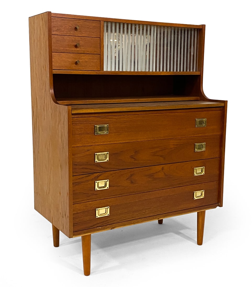 DANISH TEAK SECRETARY DESK C. 1960S: Teak secretary desk with sliding glass cabinet doors. Mirror to back of top cabinet. Brass drawer pulls in campaign style. Denmark, circa 1960s. Dimensions: H 36" x W 35" x D 18". Pull-Out Desk D 14.7