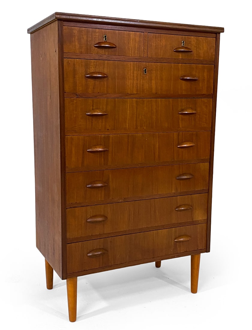 DANISH TEAK CHEST OF DRAWERS C. 1960S: Key included. Carved drawer pulls. Denmark, circa 1960s. Dimensions: H 46.5" x W 26" x D 18". Condition: Few faint water spots to top, small dings. Light surface scratches. Wear consistent with age an
