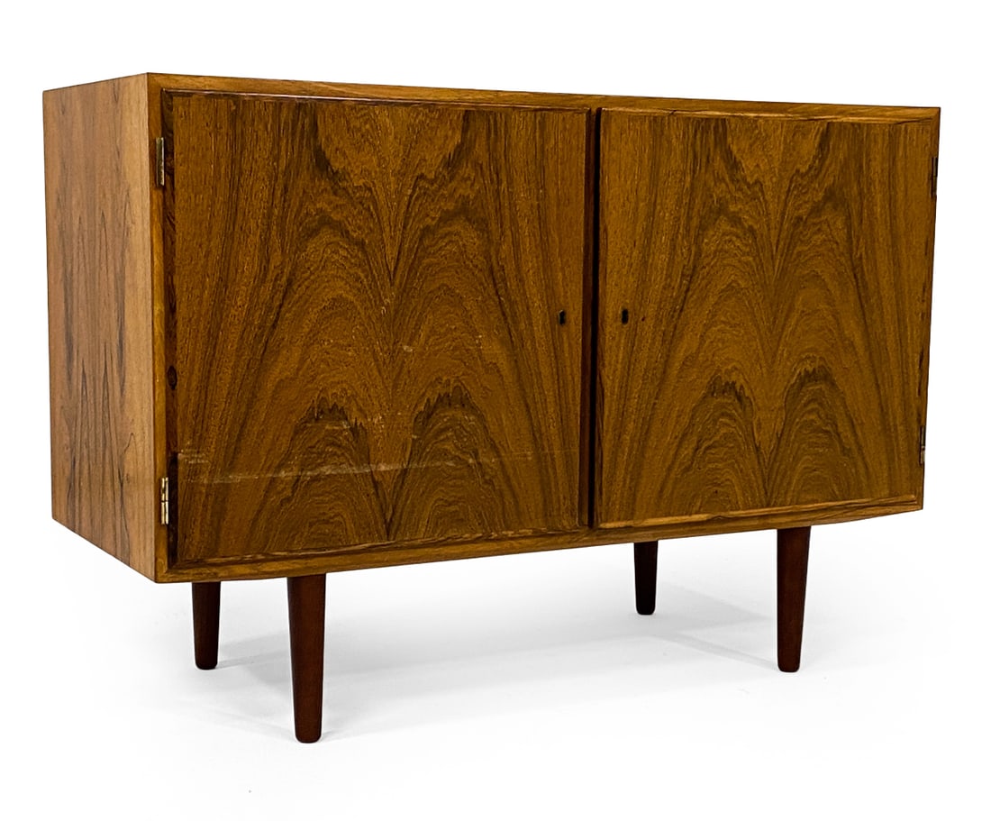 POUL HUNDEVAD DANISH ROSEWOOD CABINET C. 1960S: Key included. Stamped to back top corner. Adjustable shelves. Denmark, circa 1960s. Dimensions: H 29.5" x W 42.5" x D 17". Condition: Sun fading to top, few scratches. Scuffs to cabinet door. Wear con