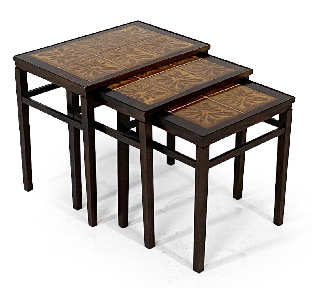 DANISH ROSEWOOD & CERAMIC TILE NESTING TABLES: (3) Rosewood nesting tables with ceramic tiles inlaid to tops. Denmark, circa 1960s. Dimensions: Largest H 19.25" x W 21.5" x W 14". Condition: Faint scuffs to wood and tiles, wear consistent with age