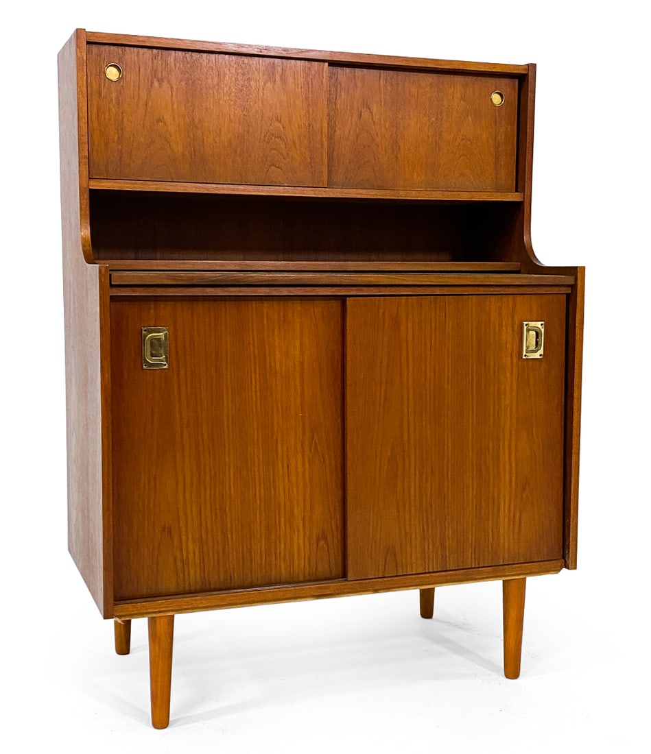 WINGE MOBLER DANISH TEAK SECRETARY DESK C. 1970S: From Winge Mobler. Tagged on back. Teak secretary desk with cabinet. Brass pulls. Tagged to back. Denmark, circa 1970s. Dimensions: H 46" x W 35" x D 18". Desk D 15". Condition: Small scuffs and dings