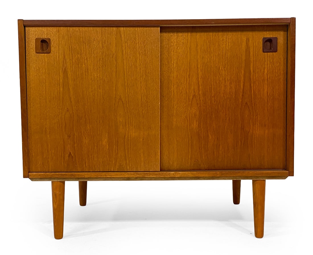 SWEDISH TEAK CABINET C. 1960S: Adjustable shelf. Molded inset cabinet door pulls. Sweden, circa 1960s. Dimensions: H 28.5" x W 35" x D 19". Condition: Sun fading to top, few filled dowel holes. Wear consistent with age and use. V09