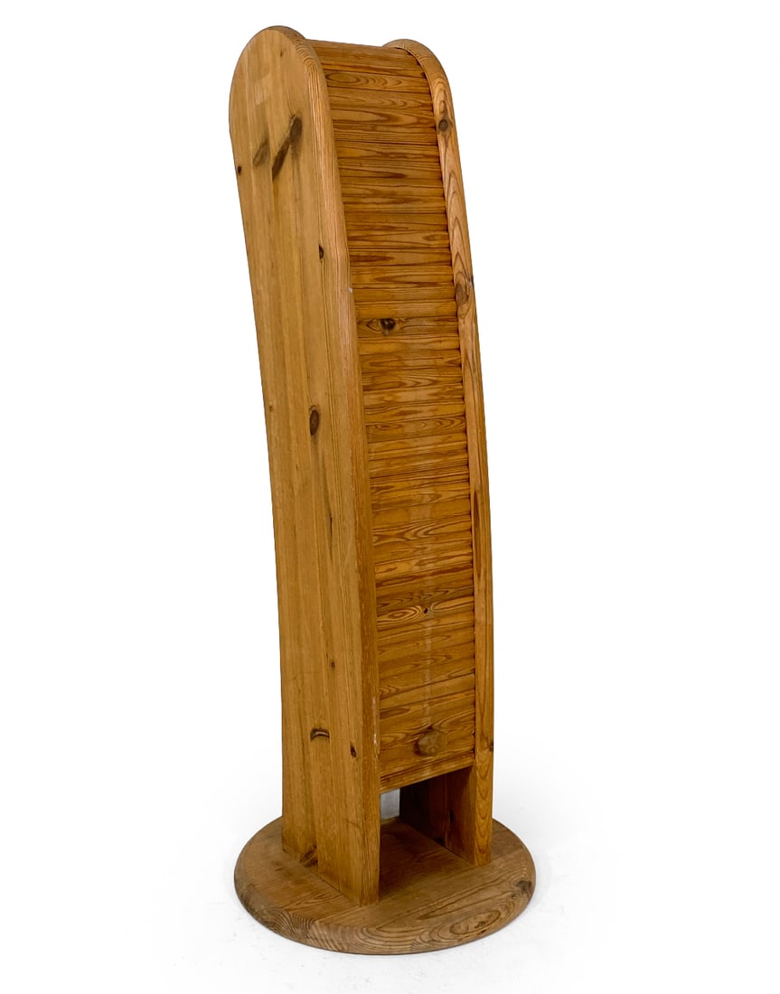 DANISH PINE TAMBOUR SHELF C. 1970S: Unique narrow shelf with tambour door. Denmark, circa 1970s. Dimensions: H 41" x Dia. 14". Condition: Slight fading and few water spots to base. Wear consistent with age and use. V059