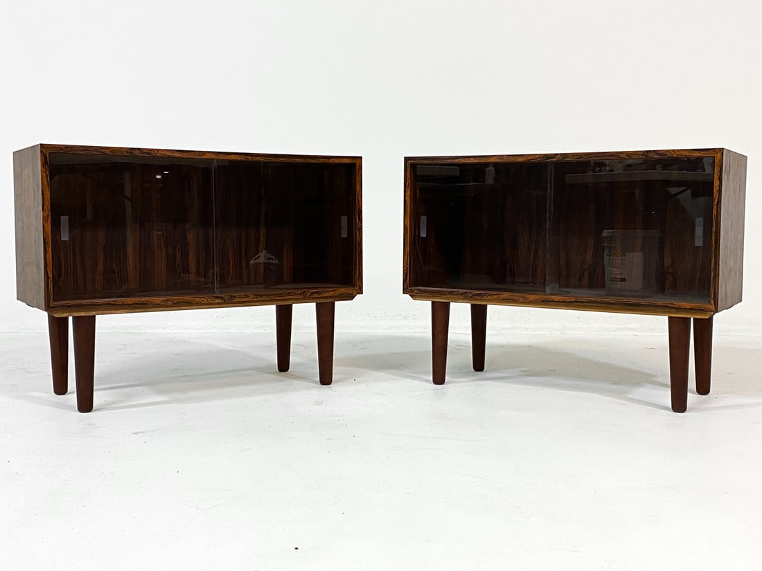 PAIR OF DANISH ROSEWOOD BOOKCASE CABINETS C. 1960S: From Gern Mobelfabriken, tagged underneath. (2) Rosewood bookcases with glass sliding doors. Denmark, circa 1960s. Dimensions: H 21" x W 28" x D 11.5". Condition: Few thin surface scratches to wood. W