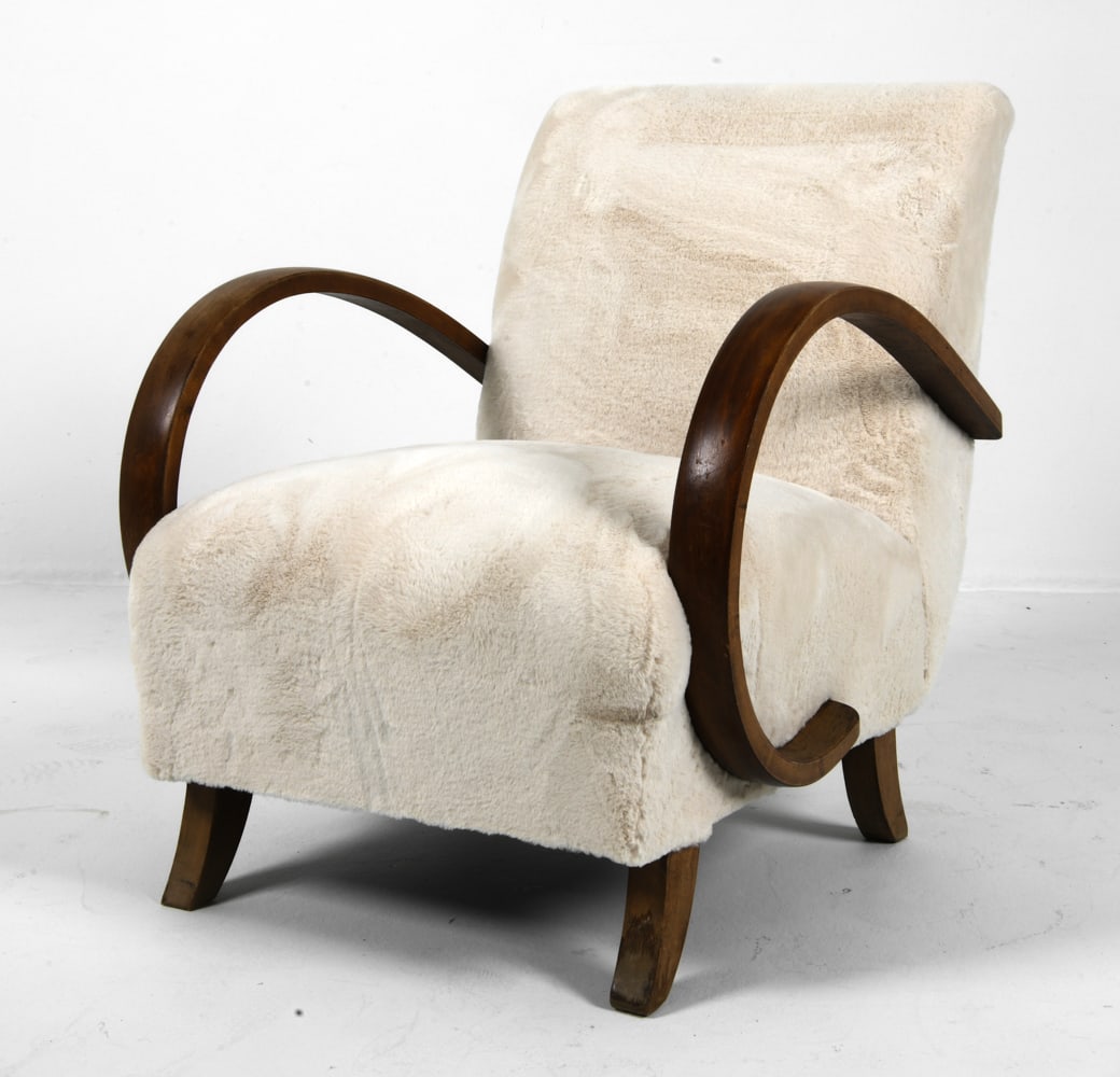 JINDRICH HALABALA FOR UP ZAVODY LOUNGE CHAIR 1960S: Beech bentwood frame and cream tone faux sheepskin upholstery. Apparently unmarked. Czechoslovakia, circa 1960s. Dimensions: H 32" x W 25" x D 30" x SH 16" Condition: Light surface wear consistent wit