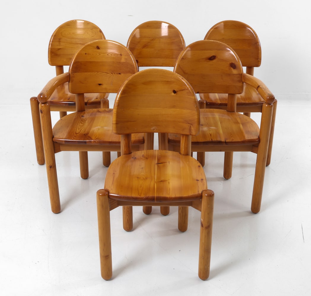 (6) RAINER DAUMILLER PINE DINING CHAIRS C. 1970S: For Hirtshals Sawmill. Six Brutalist dining chairs in pine, two with armrests. Rounded backrests and cylindrical legs. Denmark, circa 1970s. Dimensions: H 33" x W 19" x D 18" x SH 18" Condition: Wear
