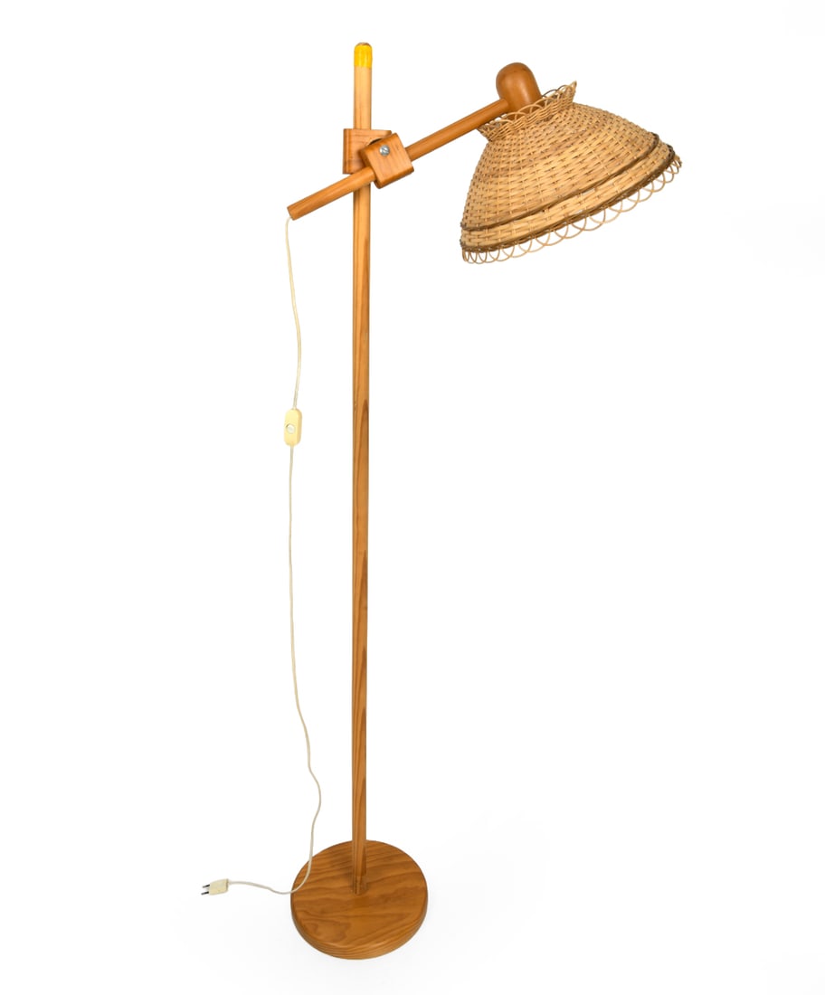 SWEDISH PINE FLOOR LAMP 1960S: Features wicker shade and round base. In pine. Sweden, 1960's. Dimension: H 64" x W 17" x D 11" Conditions: Not tested, European Plug, Wear consistent with age and use including minor rubs scuffs to b