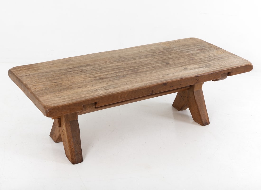 DE PUYDT BRUTALIST OAK COFFEE TABLE C. 1970S: Rectangular top and trestle-style base with angled legs and a central stretcher. Apparently unmarked. Belgium, circa 1970s. Dimensions: H 19.5" x W 59" x D 25.5" Condition: Discoloration, rubs and nic