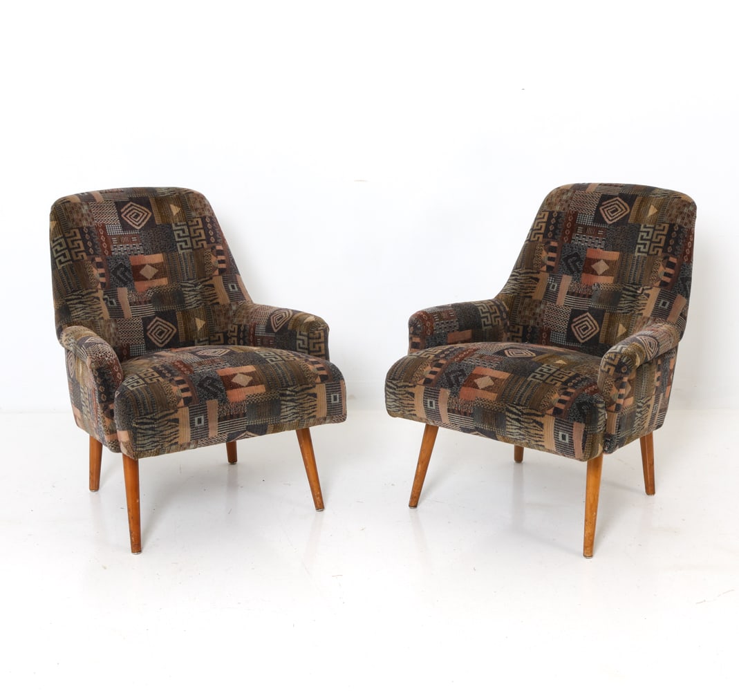 PAIR OF SCANDINAVIAN VELOUR LOUNGE CHAIRS C. 1960S: Mid-century lounge chairs in geometric pattern velour upholstery and beech legs. Rounded form with slightly curved armrests. Scandinavian, circa 1960s. Dimensions: H 30.25" x W 24.5" x D 27" x SH 16"