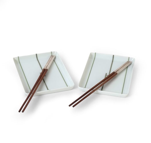 HERMES PARIS RHYTHM PLATES & CHOPSTICKS: Hermes Porcelain Paris Rhythm series sushi plates and two chopsticks in wooden part with silver-plated metal tips. Plate with green and gold lines and H mark to center. Original packaging box