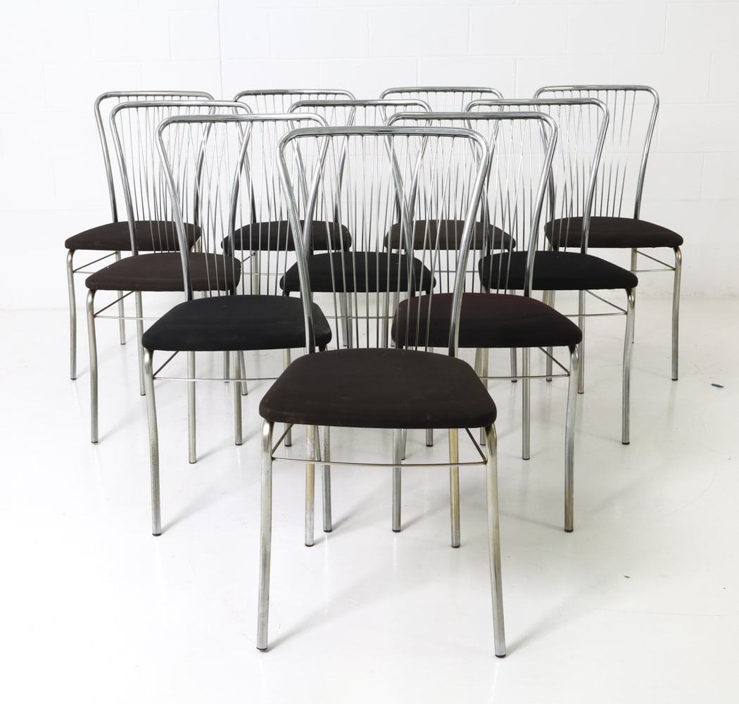 (10) ITALIAN CHROME DINING CHAIRS C. 1970S: Slatted backrest and curved legs with padded black upholstery. Italy, circa 1970s. Dimensions: H 36.25" x W 17" x D 19.5" x Sh 18.5" Condition: Fading and marks of discoloration to seats, signs of oxi