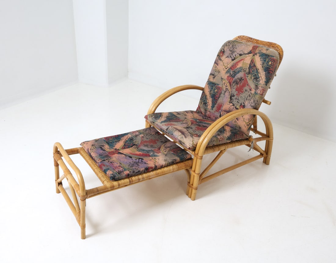 SCANDINAVIAN BAMBOO LOUNGE CHAISE 1970'S: Bamboo frame and wicker backrest lounge chair with ottoman, featuring fabric cushion. Scandinavian, circa 1970. Dimensions: (Ottoman Extended) H 36.25" x W 24.5" x D 56" x Sh 15.75" Condition: Wear