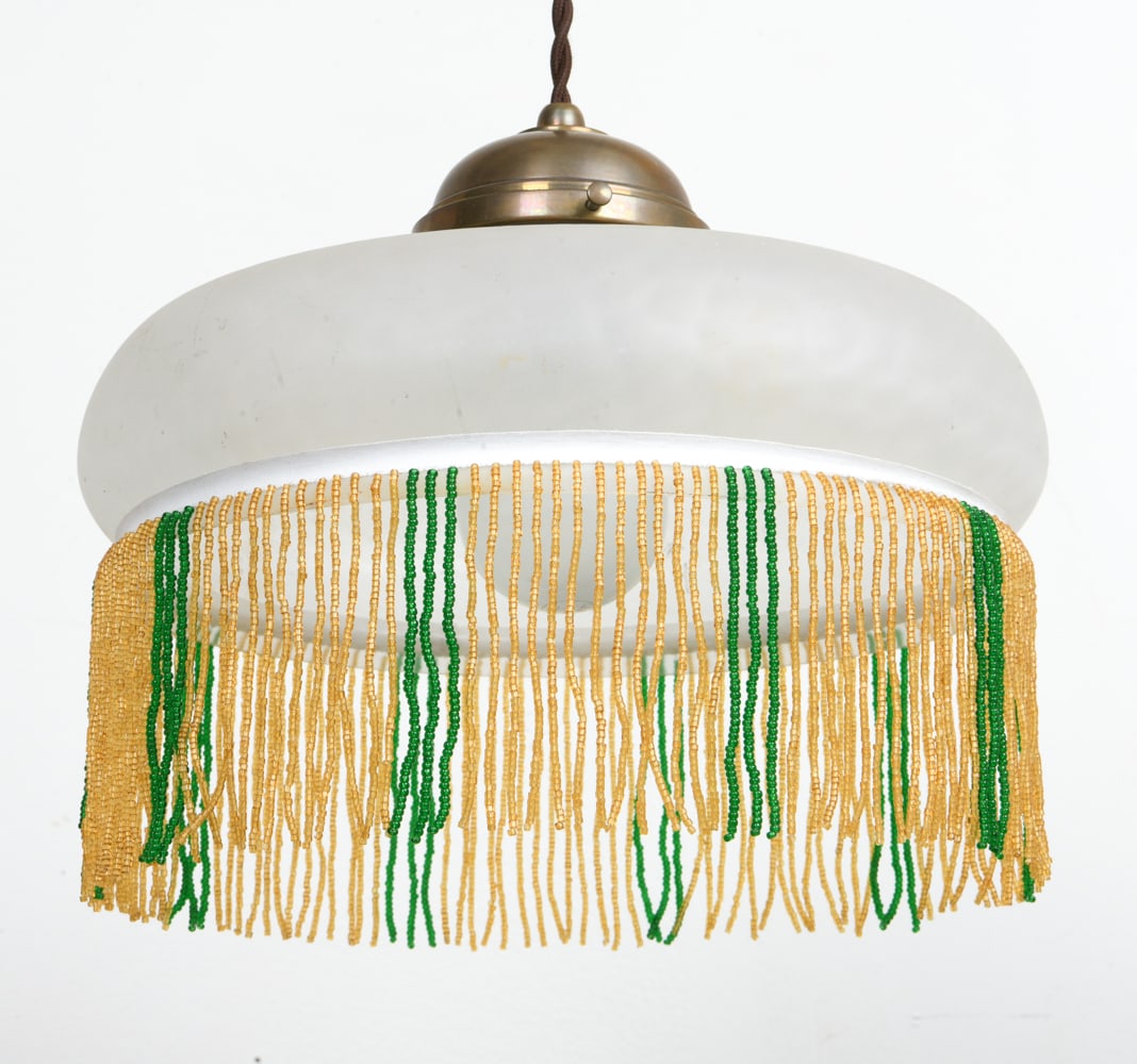 GLASS PENDANT LIGHT W/ BEADED FRINGE: Glass pendant light with beaded fringe, Brass pulley system for height adjustment. Dimensions: Shade H 7" x Dia. 11.5". Condition: Wiring untested. Faint scuffs to shade. Wear consistent with age and