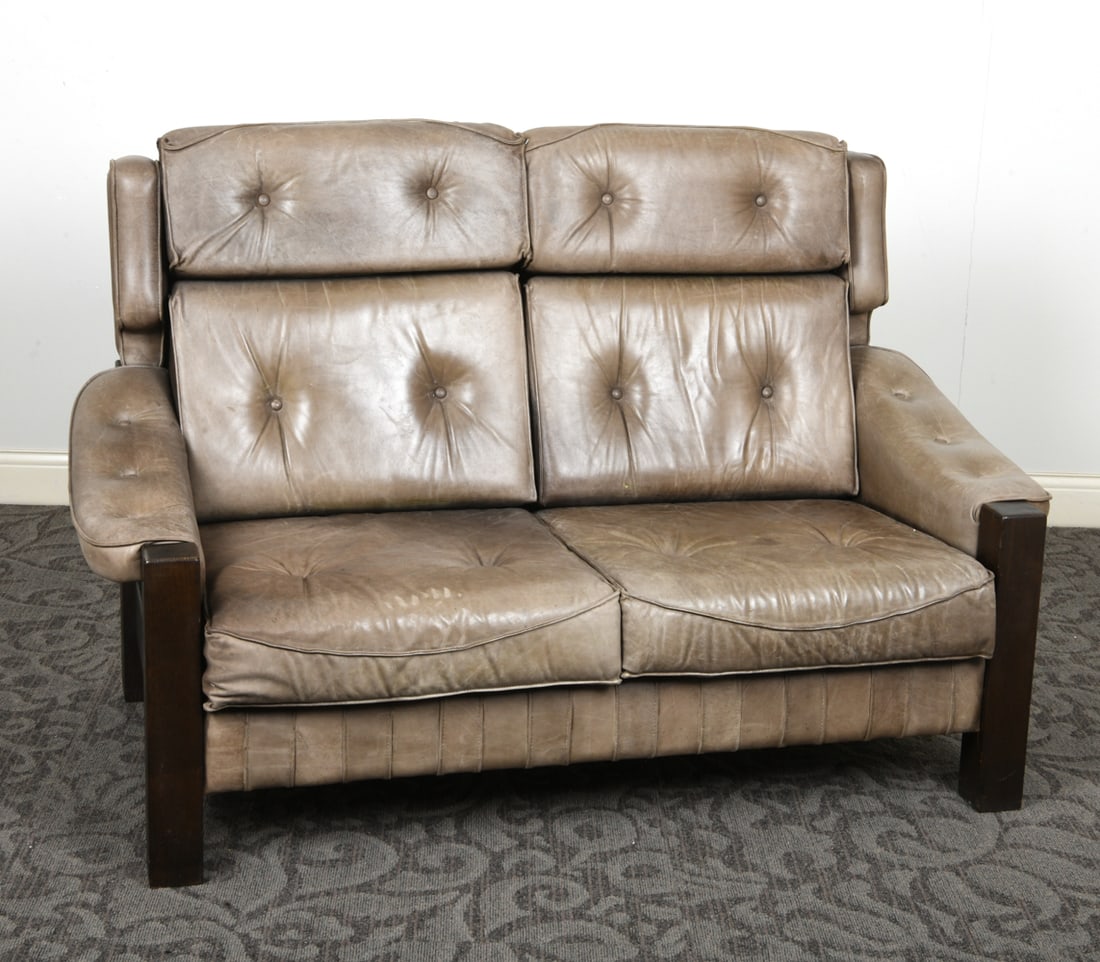 BRUTALIST SCANDINAVIAN PINE & LEATHER SOFA: Pine frame in dark stain with olive toned tufted leather upholstery. Scandinavian, circa 1960s. Dimensions: H 42" x W 63.5" x D 36" x SH 17.5". Condition: Scuffs and scratches to wood and leather.