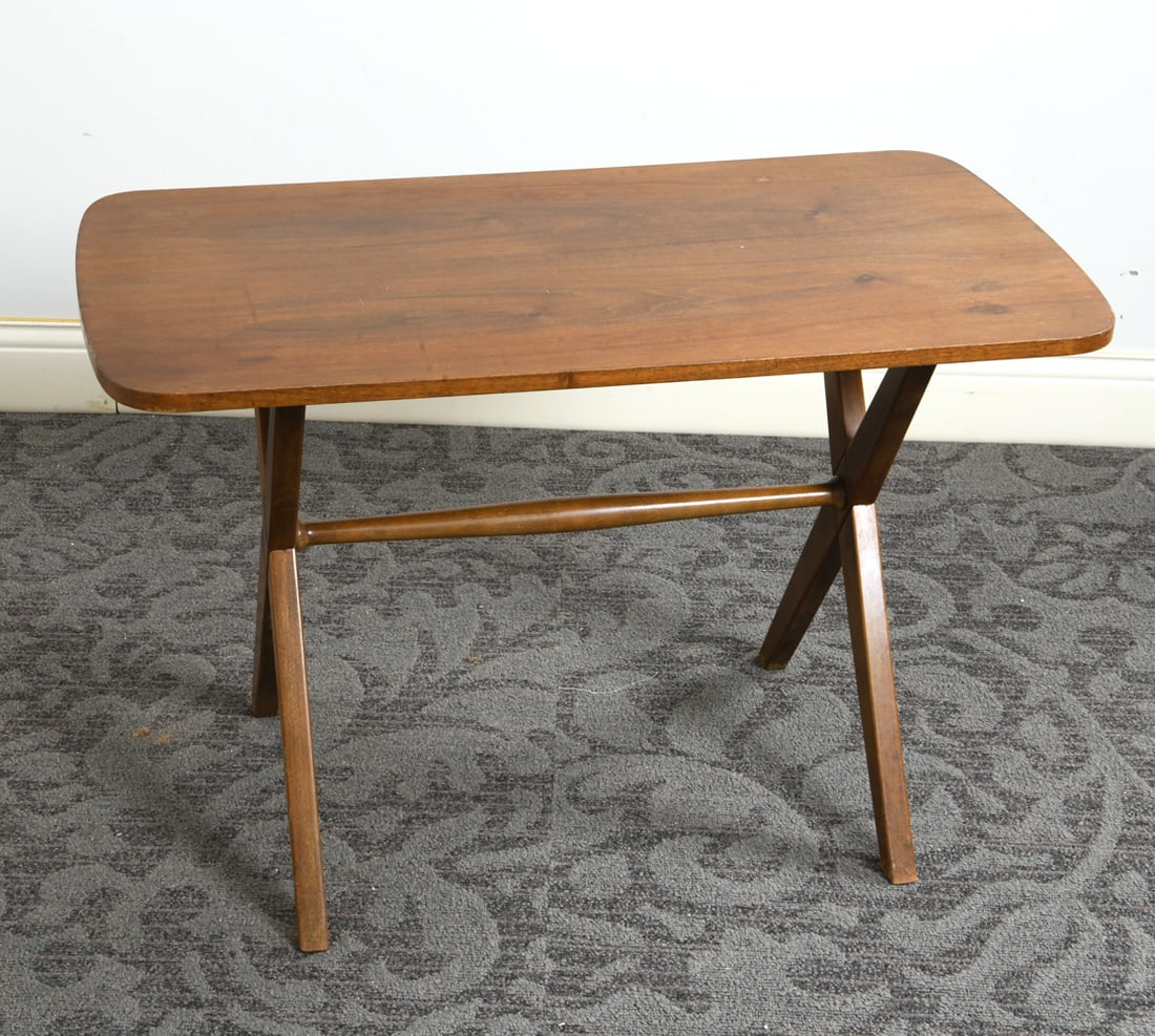 SCANDINAVIAN TEAK SIDE TABLE C. 1960S: Teak side table with cross style base. Scandinavian, circa 1960s. Dimensions: H 23.5" x W 36" x D 19". Condition: Water spots and fading to top. Wear consistent with age and use.